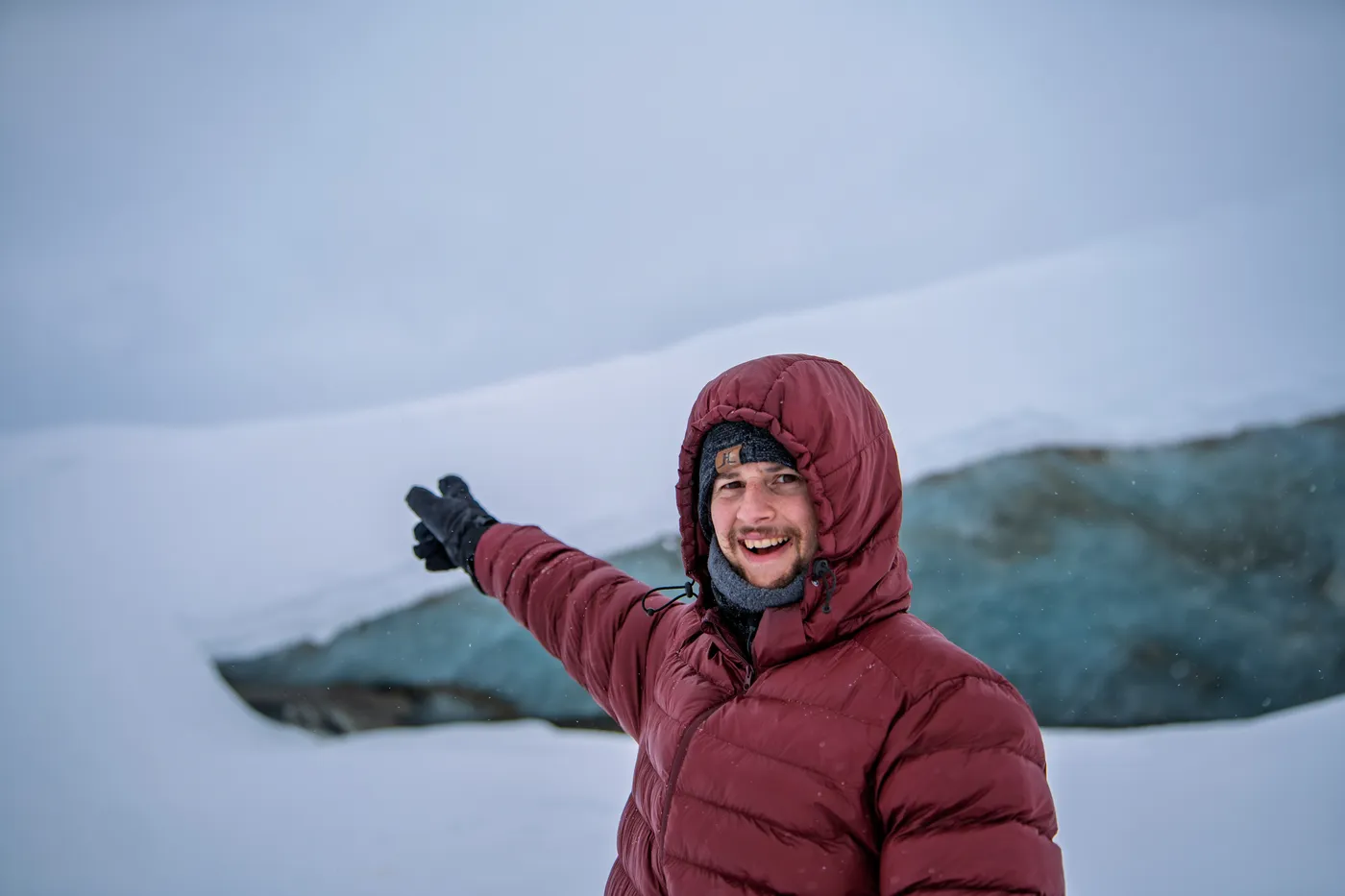 Wyatt Bange pointing out a glacier ice cave in Alaska